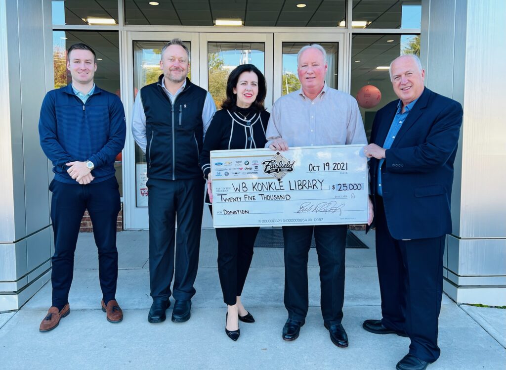 konkle library receiving giant check from fairfield auto group